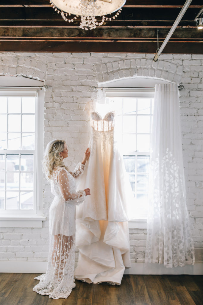 bride looking at wedding dress